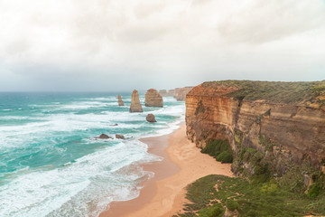 Twelve Apostles Rock Formations, Great Ocean Road, Melbourne, Australia. Road trip to australian coast line. View of rocks, cliff edge, ocean, and waves. Famous landscape tourist landmark. 12 apostles