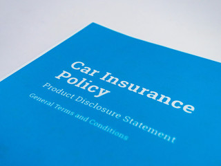 Simplistic shot of a car insurance policy paper with general terms and conditions.
