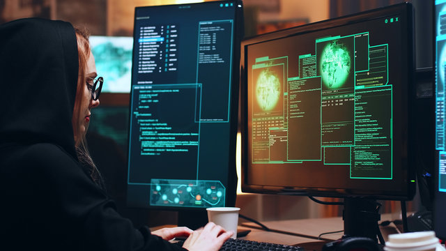 Girl hacker sitting at her super computer