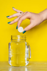 A tablet and a glass of water. Vitamin C
