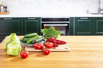Fresh vegetables on the table. Kale cabbage, tomatoes, zucchini, cucumbers, paprika, white cabbage.