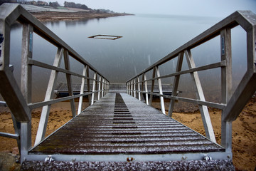 snowy footbridge on the lake