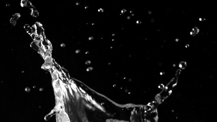 Super slow motion of splashing water crown shape on black background. Filmed on high speed cinema camera, 1000fps. - Powered by Adobe