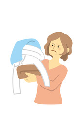 洗濯物の山を抱えて困る女性