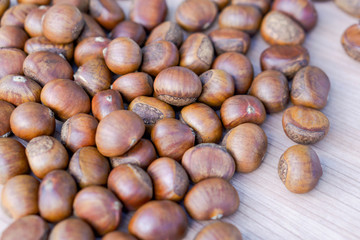 Closeup horse chestnuts on wooden table background, healthy food concept