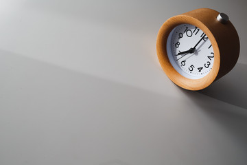 Alarm clock on white table background with empty space