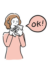 	スマートフォンでOKをタップする女性