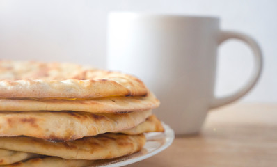 a stack of freshly made bread cakes on a white plate