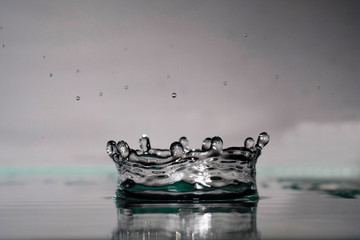 a splash of water like a crown on a light blurred background