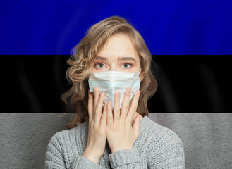 Afraid woman in medical mask on Estonian flag background. Flu epidemic and domestic violence in  Estonia concept