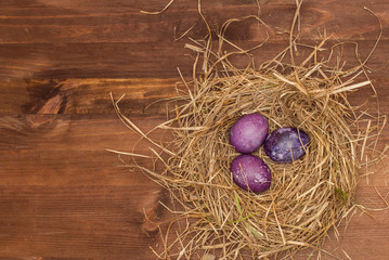 Easter, Easter eggs collection as background.
Easter eggs on a brown wooden table.
Easter eggs and hay. In the form of space or the universe eggs in the nest.