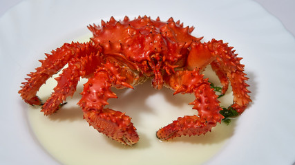 Kamchatka red king crab is boiled in boiling water in a pan.