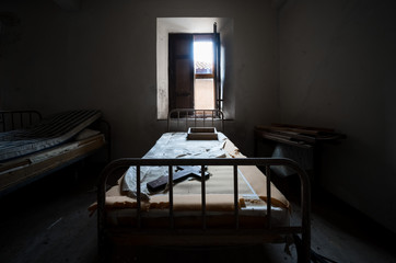 Dark and scary bedroom of an abandoned house