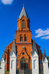 Fototapeta na wymiar Old beautiful red brick church on a sunny day.
