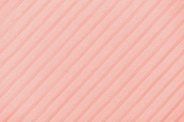 Plisse background toned in trendy color 2020 coral pink. geometric cloth lines. Fabric, textile...