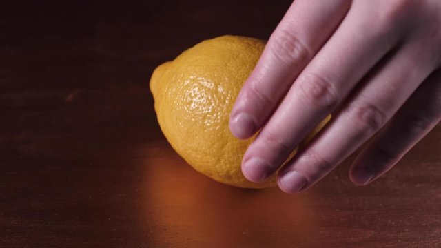 A hand holding a fruit
