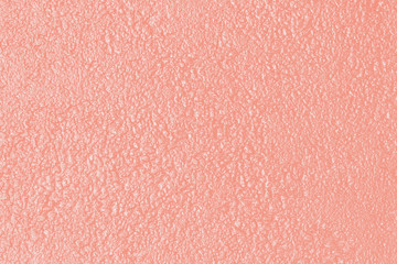 Wet abstract background. Texture toned in trendy color of 2020 coral pink.