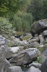 Fototapeta na wymiar small waterfall and stones in the mountain park