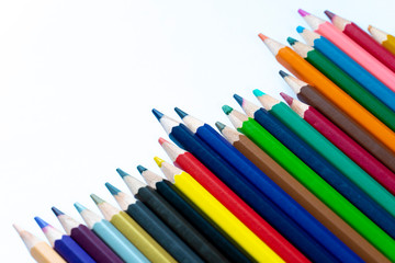 Fototapeta premium Top view colored pencils on a white background.