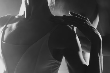 Pair touching each other with hands and passion. Love concept. Professional, sensual ballet dancers performed by sexual couple in white wear. Black and white.