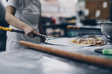 Fototapeta premium Close up shot of pizza making or preparing process