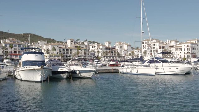 Beautiful panoramic view of "Puerto de la Duquesa" Yachts and boats docked in the Harbour. Luxury Apartment Urbanisation and Restaurants. No camera movement