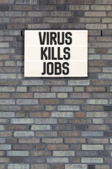 Fototapeta na wymiar Virus Kills Jobs words in light box letters, corona virus pandemic buzwword headline