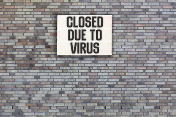 Fototapeta na wymiar Closed Due to Virus words in light box letters, corona virus pandemic buzwword headline