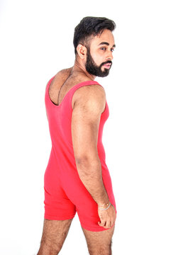 Handsome young male Asian wrestler wearing red body suit or unitard, isolated on white background