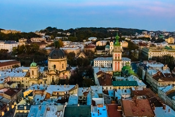 Fototapeta na wymiar View on Dominican cathedral, Dormition church and historic center of the Lviv at sunset. View on Lvov cityscape from the town hall