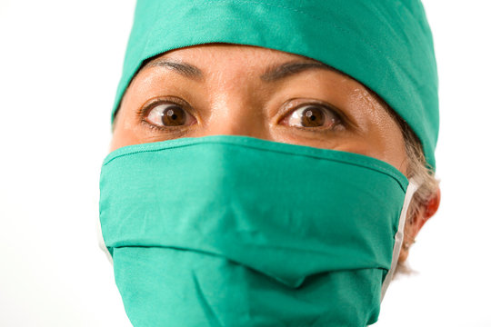 Closeup Portrait Of Mature Attractive Medicine Doctor Woman Or Hospital Nurse In Medical Scrubs And Mask Looking Intense To Camera