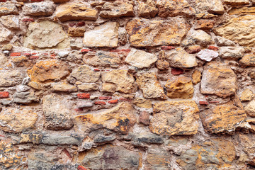Texture of antique masonry wall. Texture of a stone wall. (Multi-colored bricks)