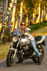 Sexy girl on a classic motorcycle.