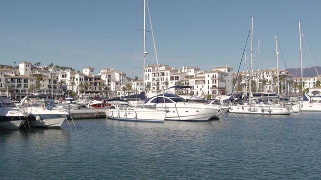 MANILVA, MALAGA / Spain - December 14 2019: Beautiful panoramic view of "Puerto de la Duquesa" Yachts and boats docked in the Harbour. Luxury Apartment Urbanisation and Restaurants. No camera movement