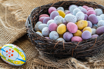 Colorful Easter chocolate eggs in a nest.