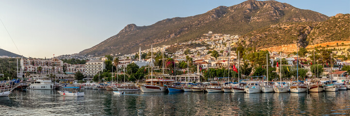Fototapeta na wymiar View across the tourist boats to Kalkan Old Town and the hills above