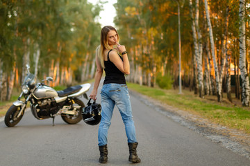 Sexy girl near a classic motorcycle