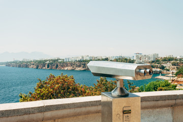 Binoculars with a view to the mountains and the sea