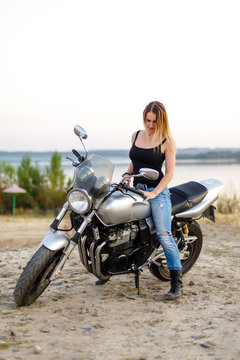 Sexy girl on a classic motorcycle.