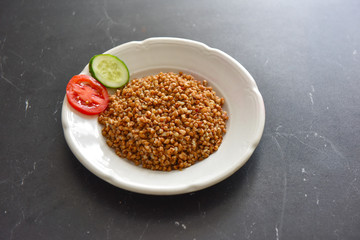 vegetarian food buckwheat with vegetables on the table