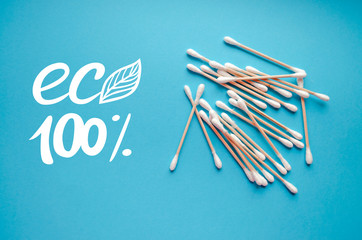 Wooden ear sticks. Ecological product. Zero waste and recycling. Organic cotton sticks for self hygiene. No plastic. Banner template with lettering on the blue background.