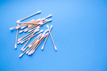 Wooden ear sticks on the blue background. Zero waste and recycling. Eco friendly products. Banner template with copy space. Organic cotton sticks for self hygiene. No plastic.