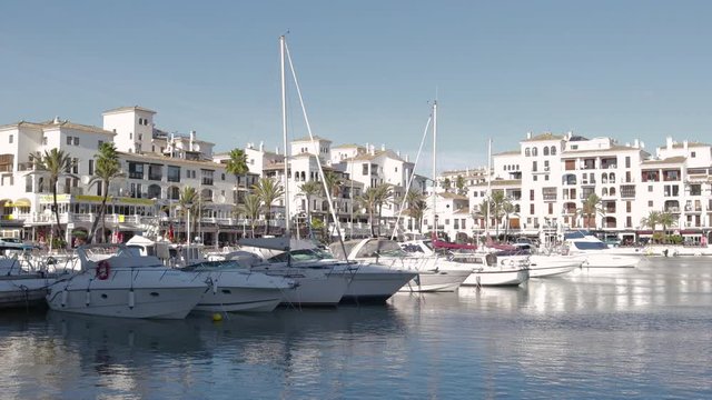 MANILVA, MALAGA / Spain - December 14 2019: Beautiful panoramic view of "Puerto de la Duquesa" Yachts and boats docked in the Harbour. Luxury Apartment Urbanisation and Restaurants. No camera movement