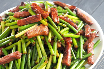 Stir fried Garlic Shoots with pork. Chinese food.