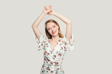 Cheerful young woman with ginger hair. Redhead model posing on white background