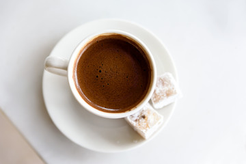 Cup of Greek - Turkish coffee isolated on white background with sweety delight