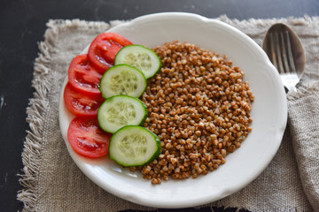 vegetarian food buckwheat with vegetables on the table