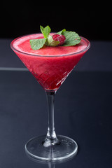 .Red refreshing alcoholic strawberry cocktail garnished with mint and cinnamon. strawberry smoothie