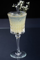 refreshing alcoholic cocktail made of pineapple juice decorated with mint and flowers