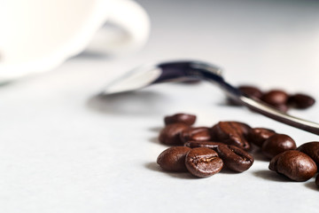 Coffee beans and a white Cup